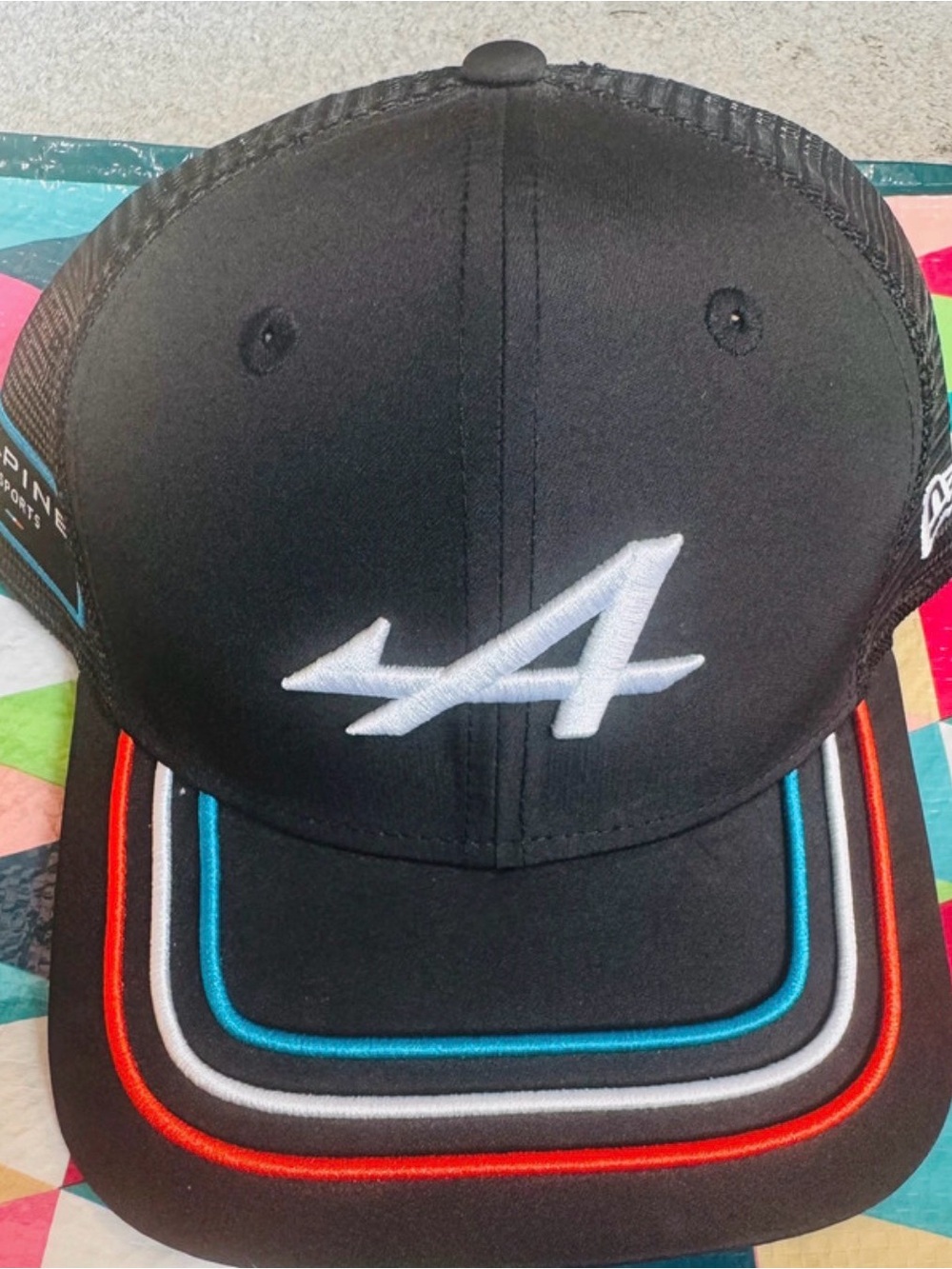 Alpine Black Cap with White 'A' Logo and Red, Blue, Gray Piping